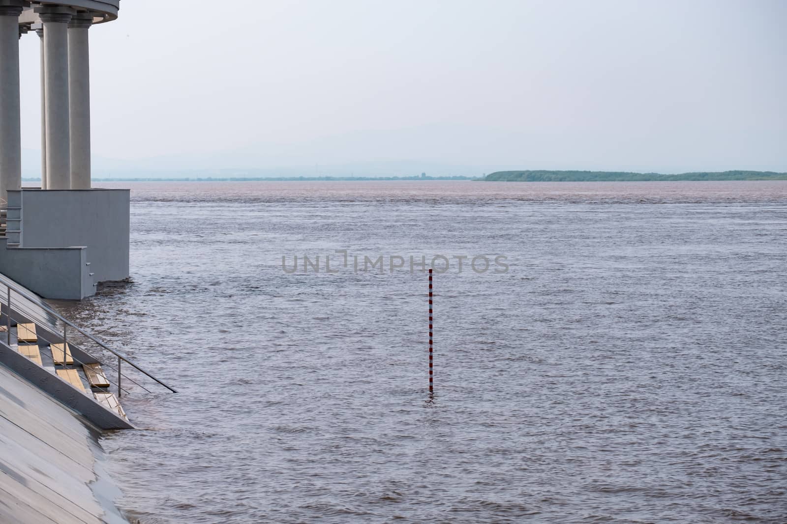 Khabarovsk, Russia - Aug 08, 2019: Flood on the Amur river near the city of Khabarovsk. The level of the Amur river at around 159 centimeters. by rdv27