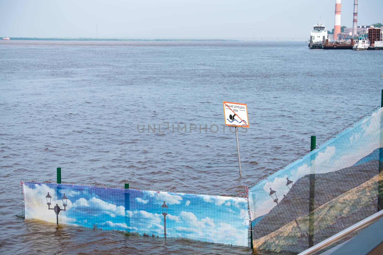 Khabarovsk, Russia - Aug 08, 2019: Flood on the Amur river near the city of Khabarovsk. The level of the Amur river at around 159 centimeters. by rdv27