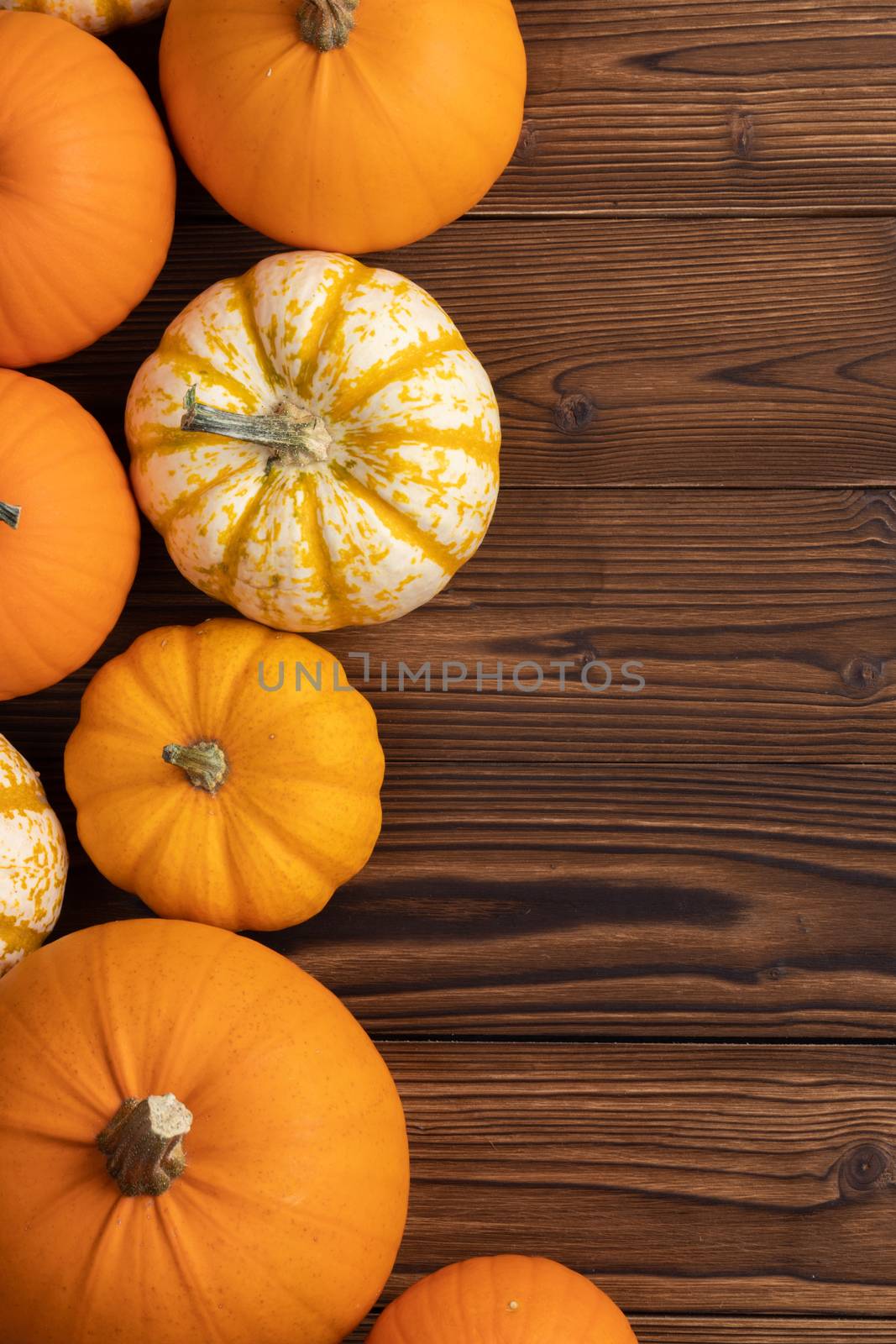 Many orange pumpkins on wooden background , Halloween concept , top view with copy space