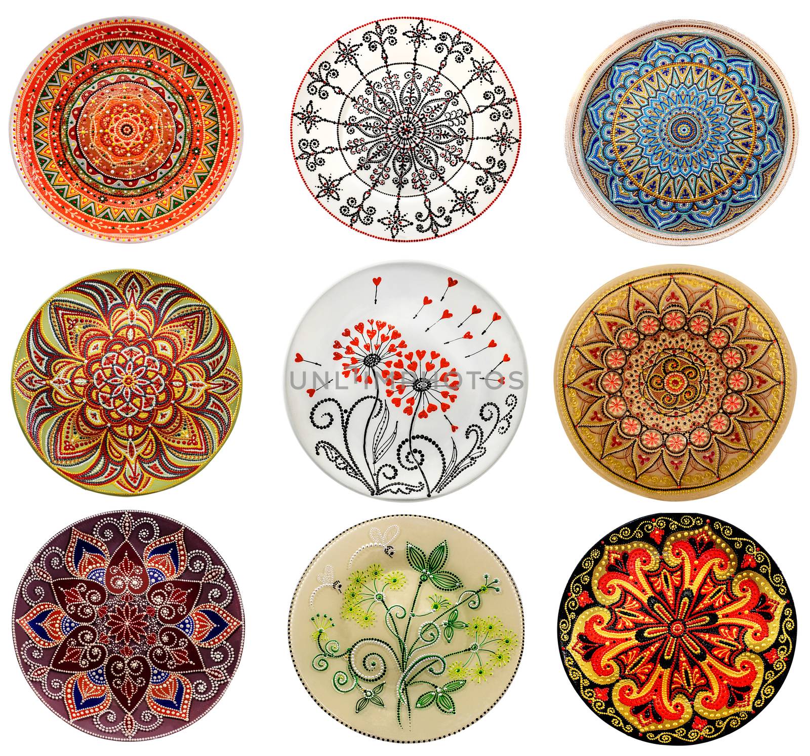 Set of decorative ceramic dishes hand-painted with acrylic paints floral pattern isolated on white background.