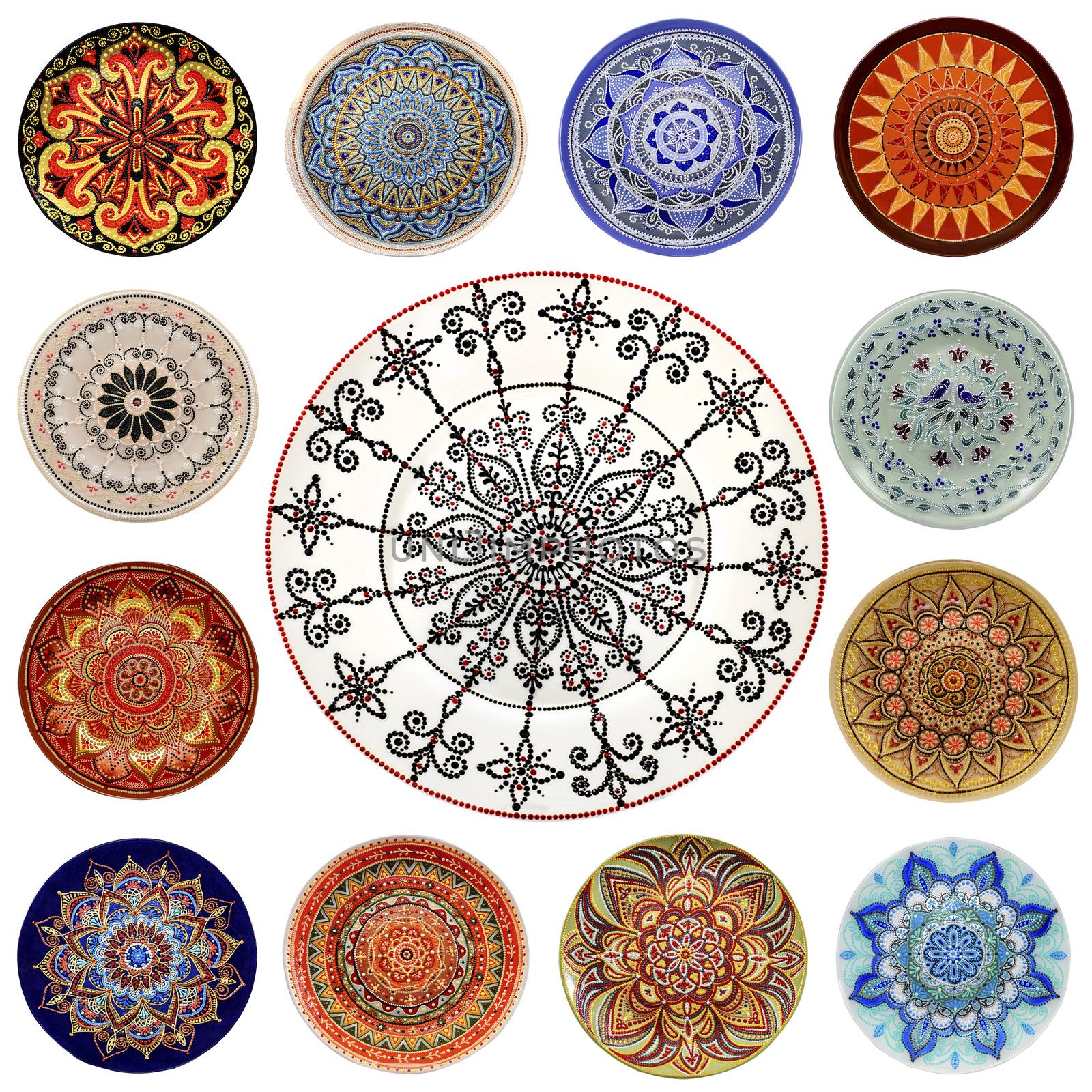 Set of decorative ceramic dishes hand-painted with acrylic paints floral pattern isolated on white background.