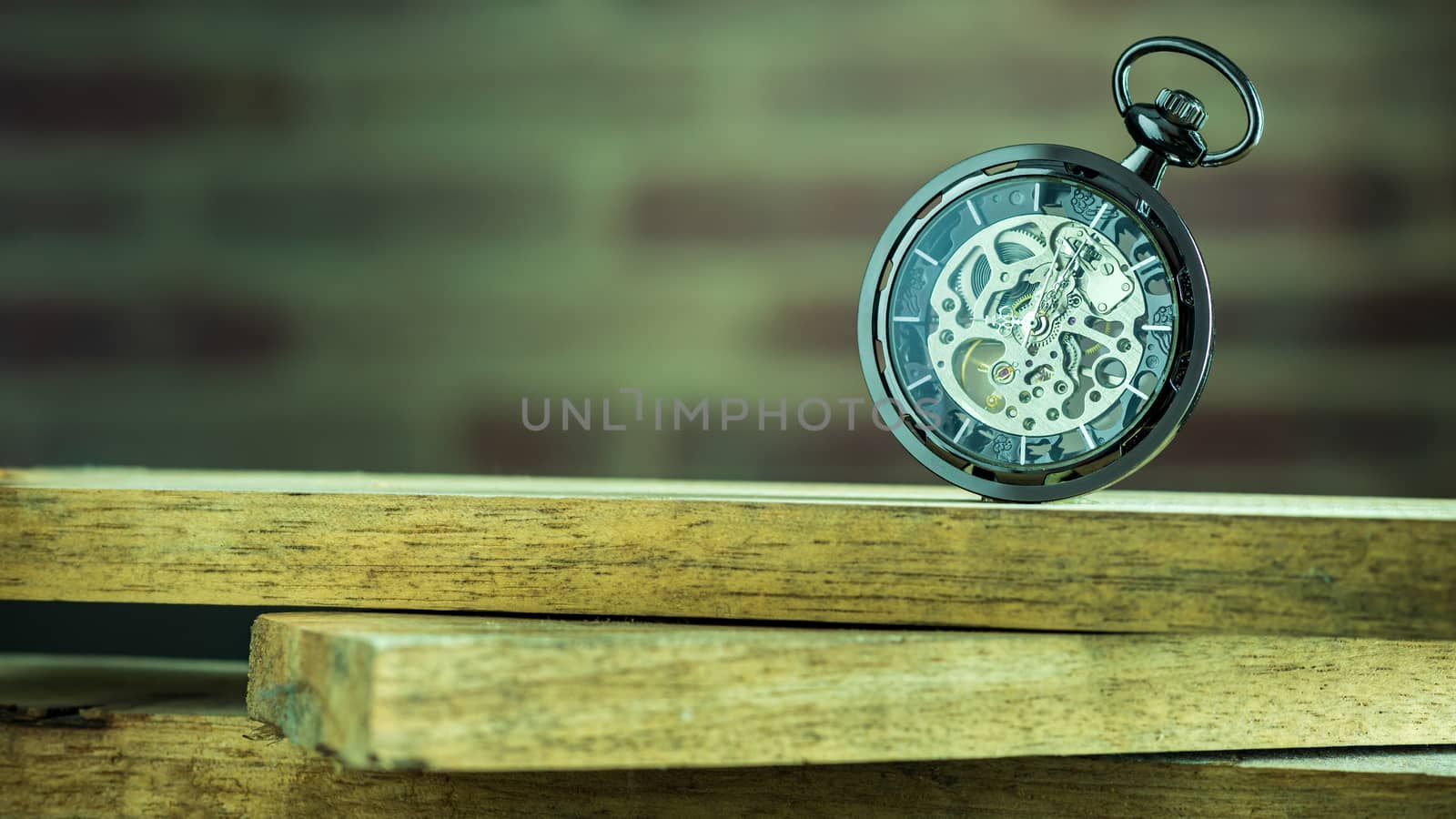 Pocket watch on stacked lumber in morning. At 8 am. o'clock. Concept of starting work today.