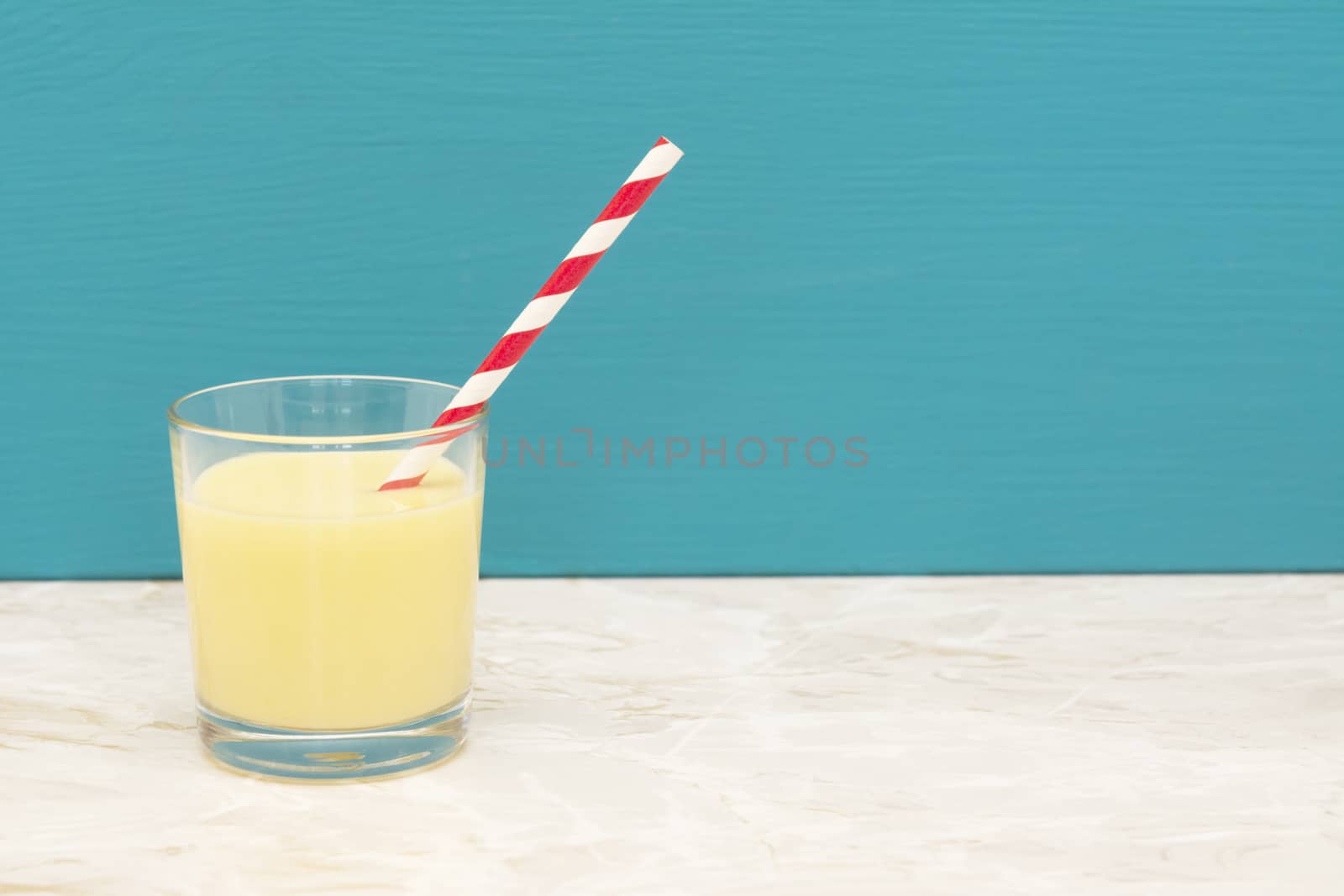 Tasty banana milkshake with a straw in a glass  by sarahdoow