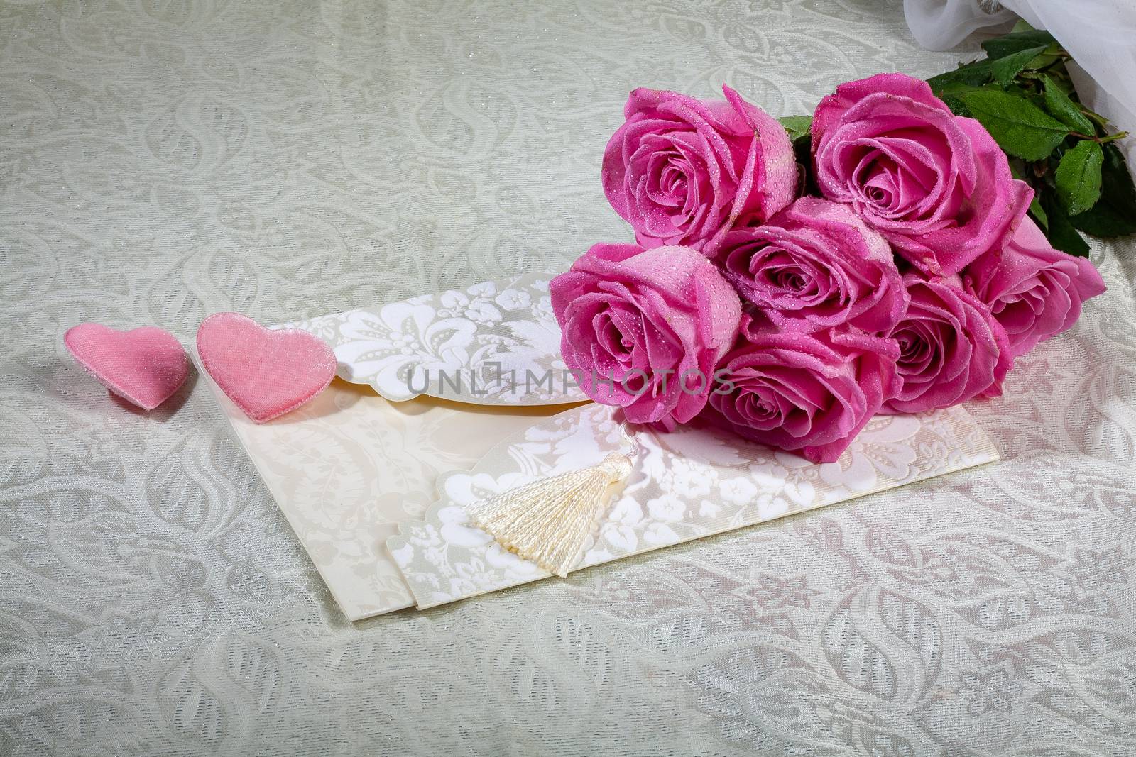 Bouquet and two hearts on a textured background