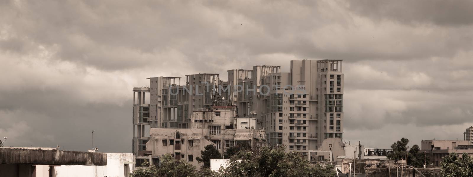 Storms dark early monsoons over modern residential skyscrapers. Kolkata, Bengal India. Monsoon Rainy day city in evening. Heavy Stormy rain clouds up above highrise. A landscape nature Photography.