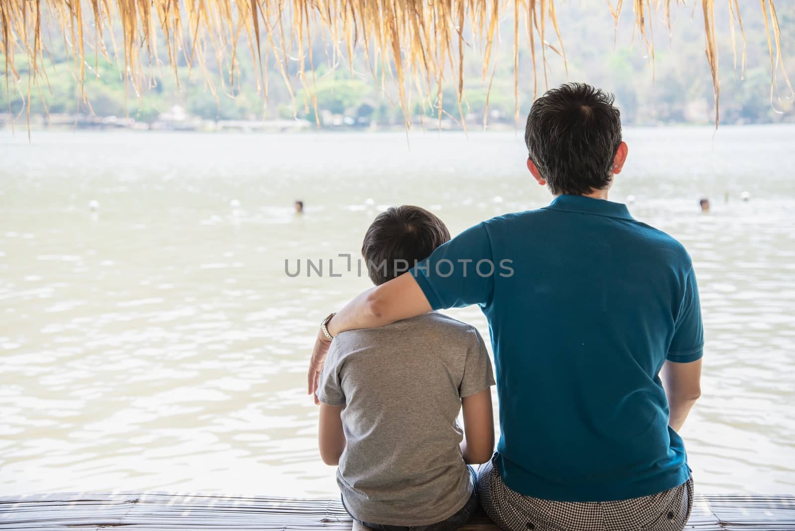 Happy dad and son during vacation at water site nature by pairhandmade
