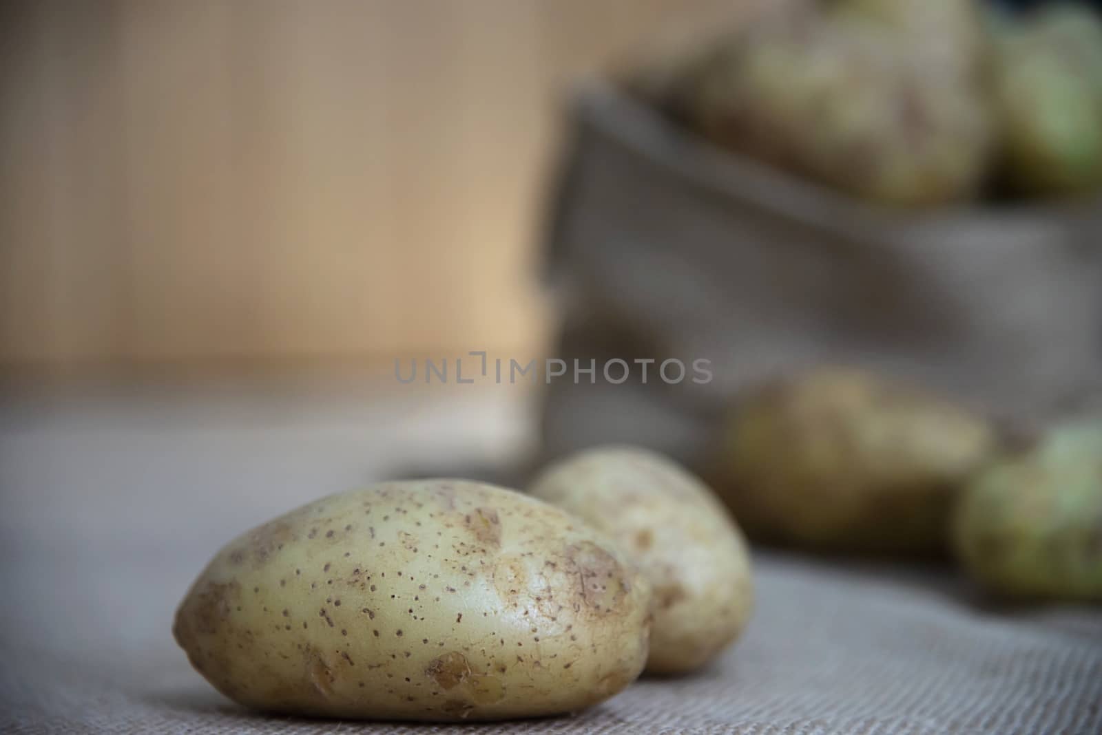 Fresh potato ready for cooking with potato sack background - potato cooking concept by pairhandmade