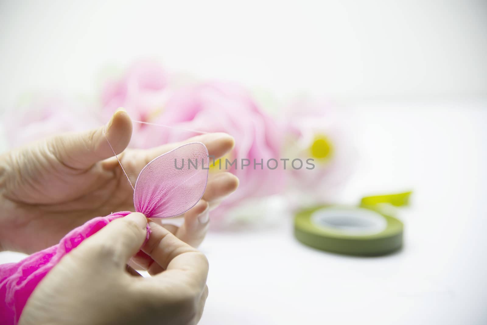 Woman making beautiful nylon flower - people with DIY handmade flower concept by pairhandmade