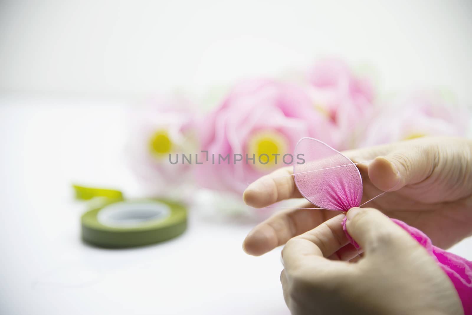 Woman making beautiful nylon flower - people with DIY handmade flower concept by pairhandmade