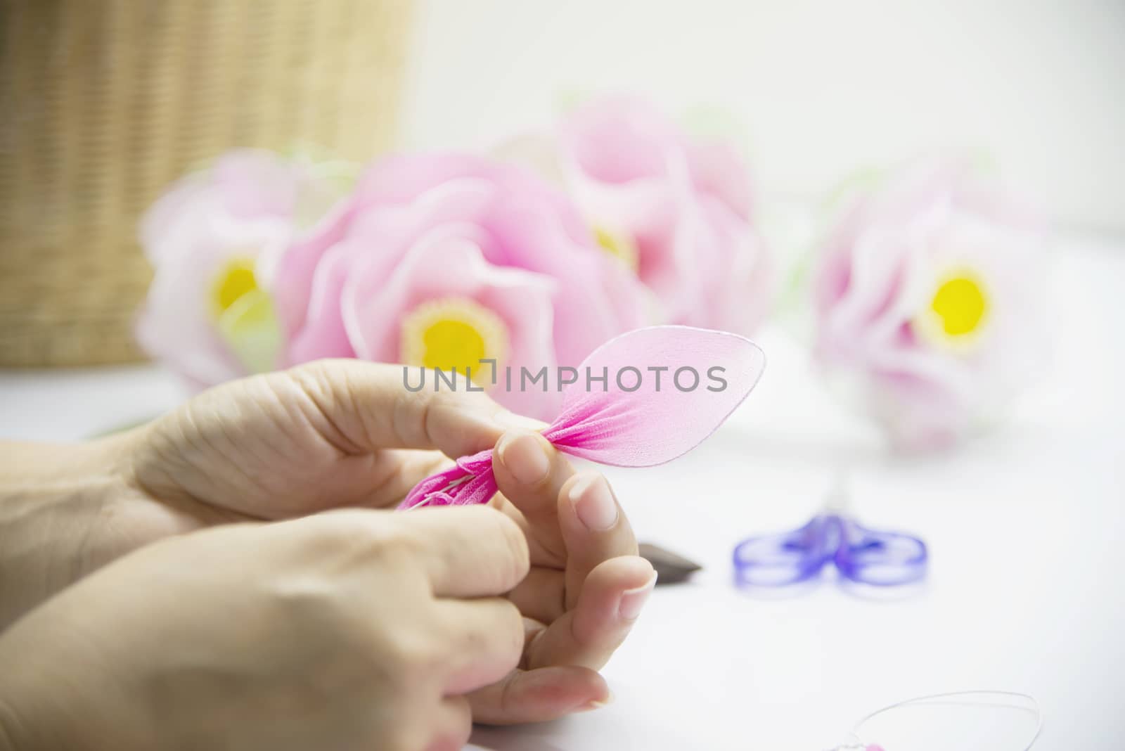 Woman making beautiful nylon flower - people with DIY handmade flower concept by pairhandmade