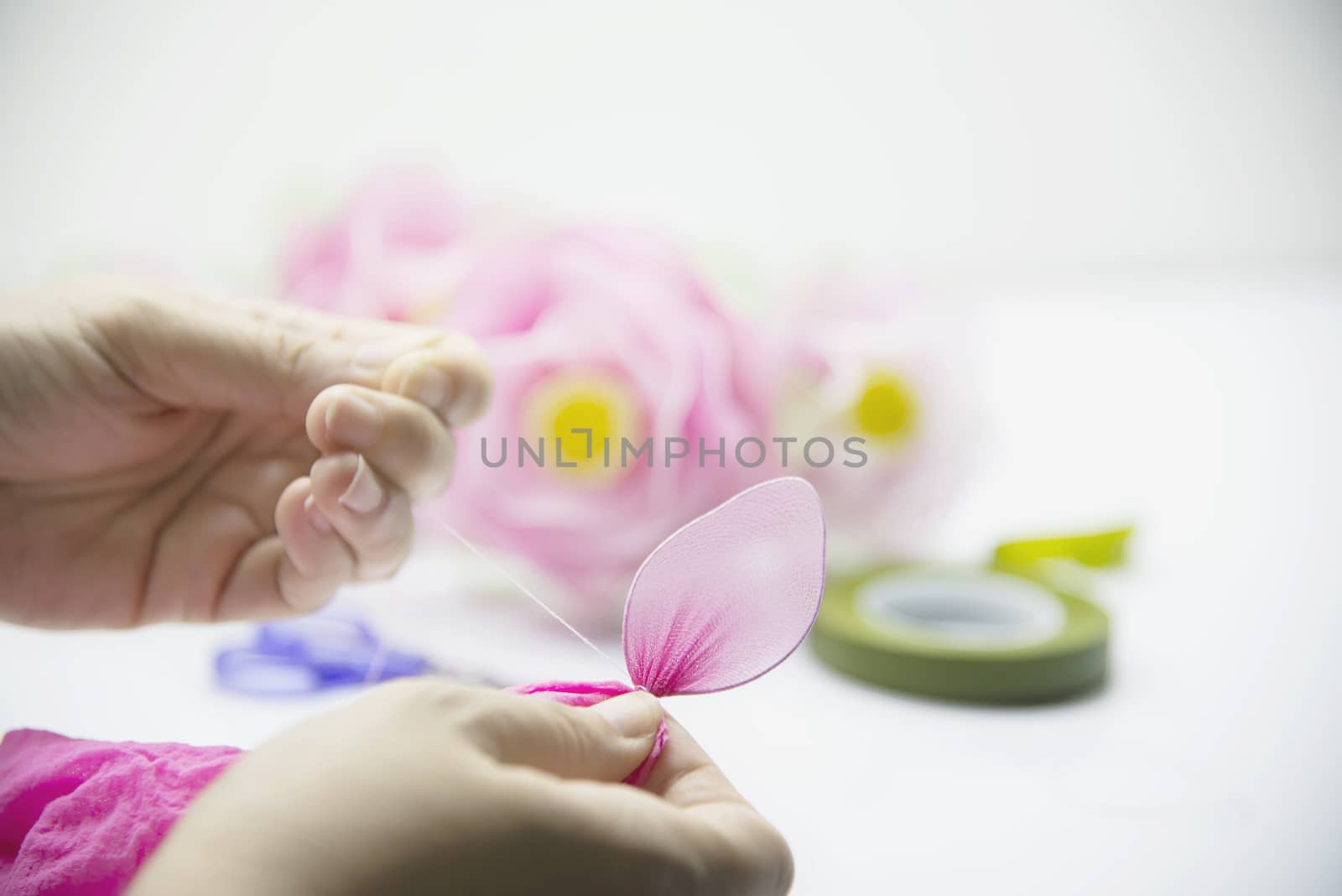 Woman making beautiful nylon flower - people with DIY handmade flower concept by pairhandmade