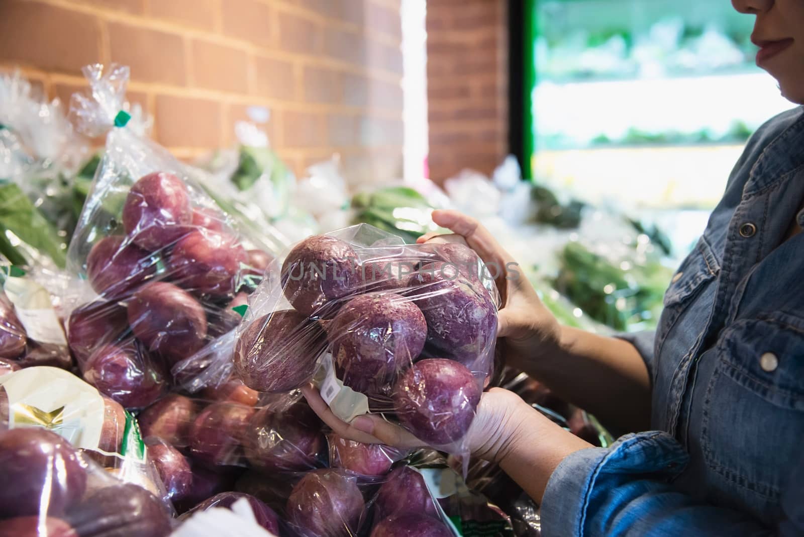 Lady is shopping fresh vegetable in supermarket store - woman in fresh market lifestyle concept by pairhandmade