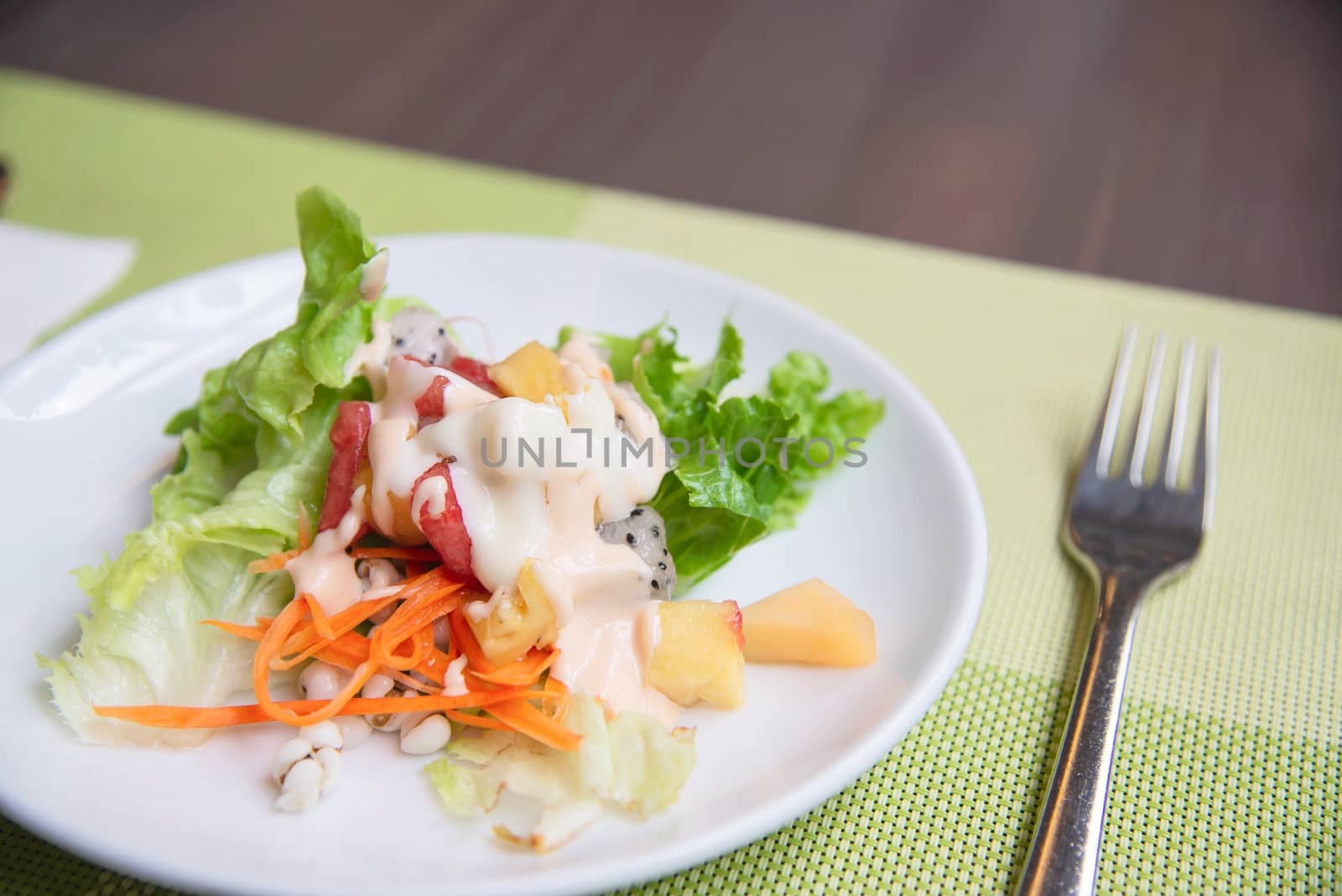 Fresh vegetable healthy salad on white plate ready for eating - fresh healthy food concept by pairhandmade