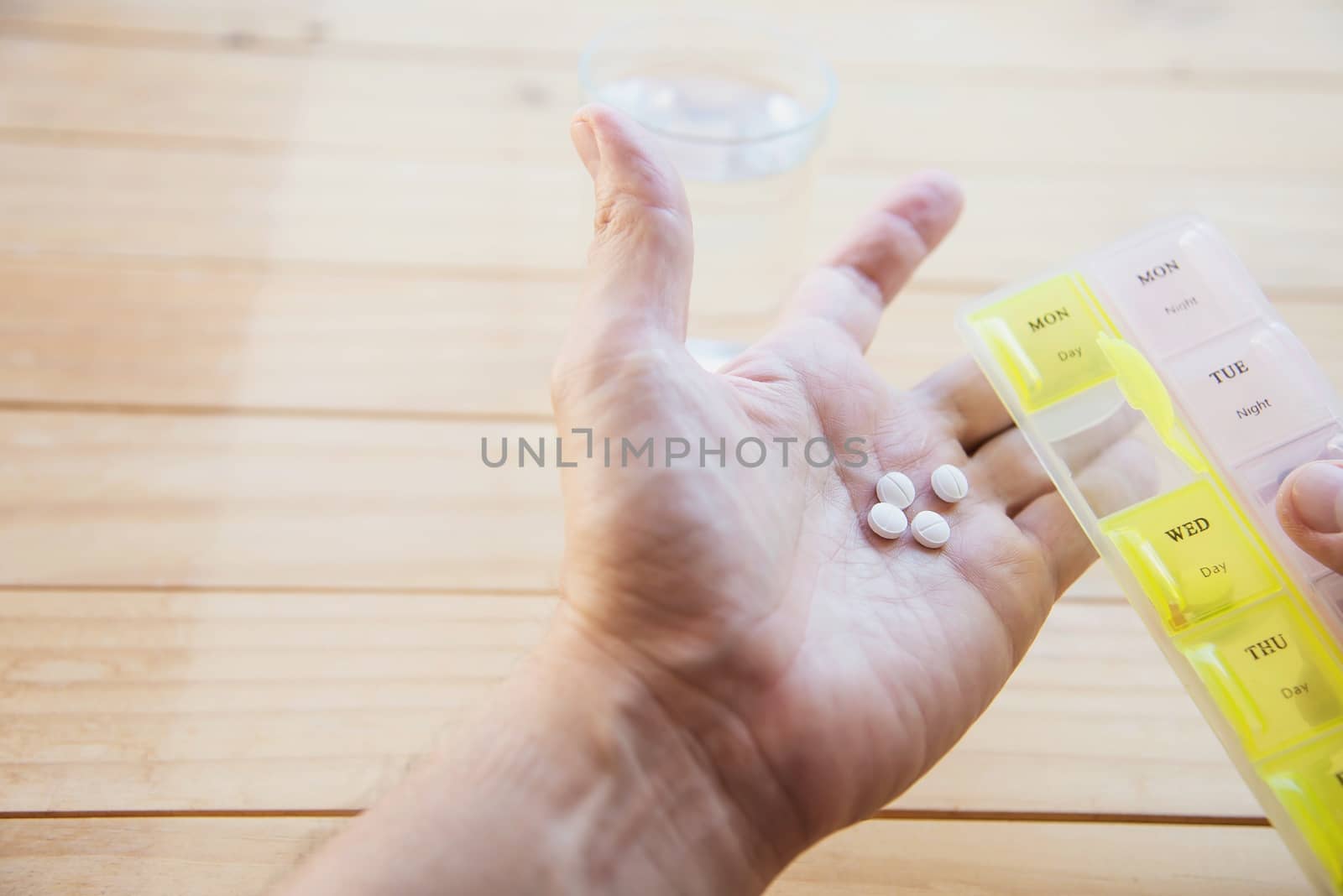 Man is going to eat medicine tablet - people with medical health problem concept by pairhandmade