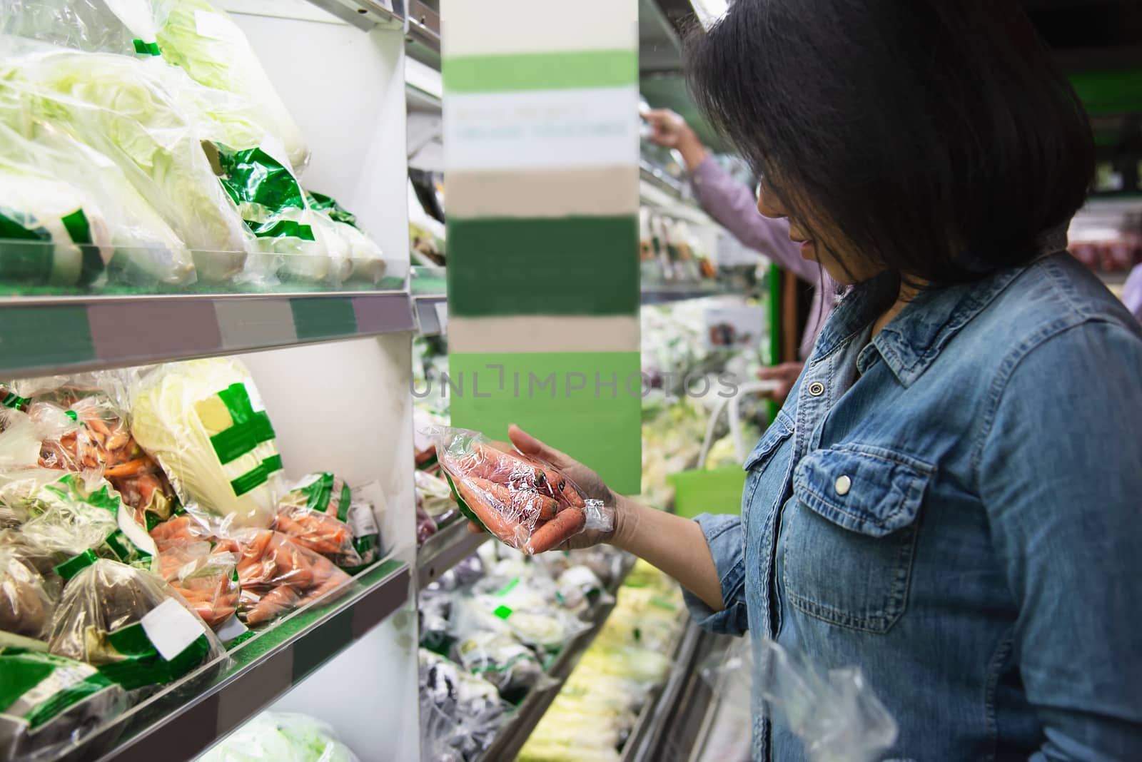 Lady is shopping fresh vegetable in supermarket store - woman in fresh market lifestyle concept by pairhandmade