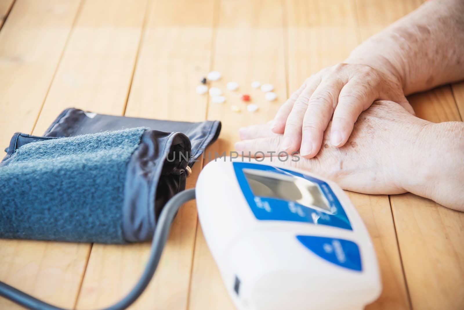 Old lady is being checked blood pressure using blood pressure monitor kid set - people with health care medical instrument set concept by pairhandmade