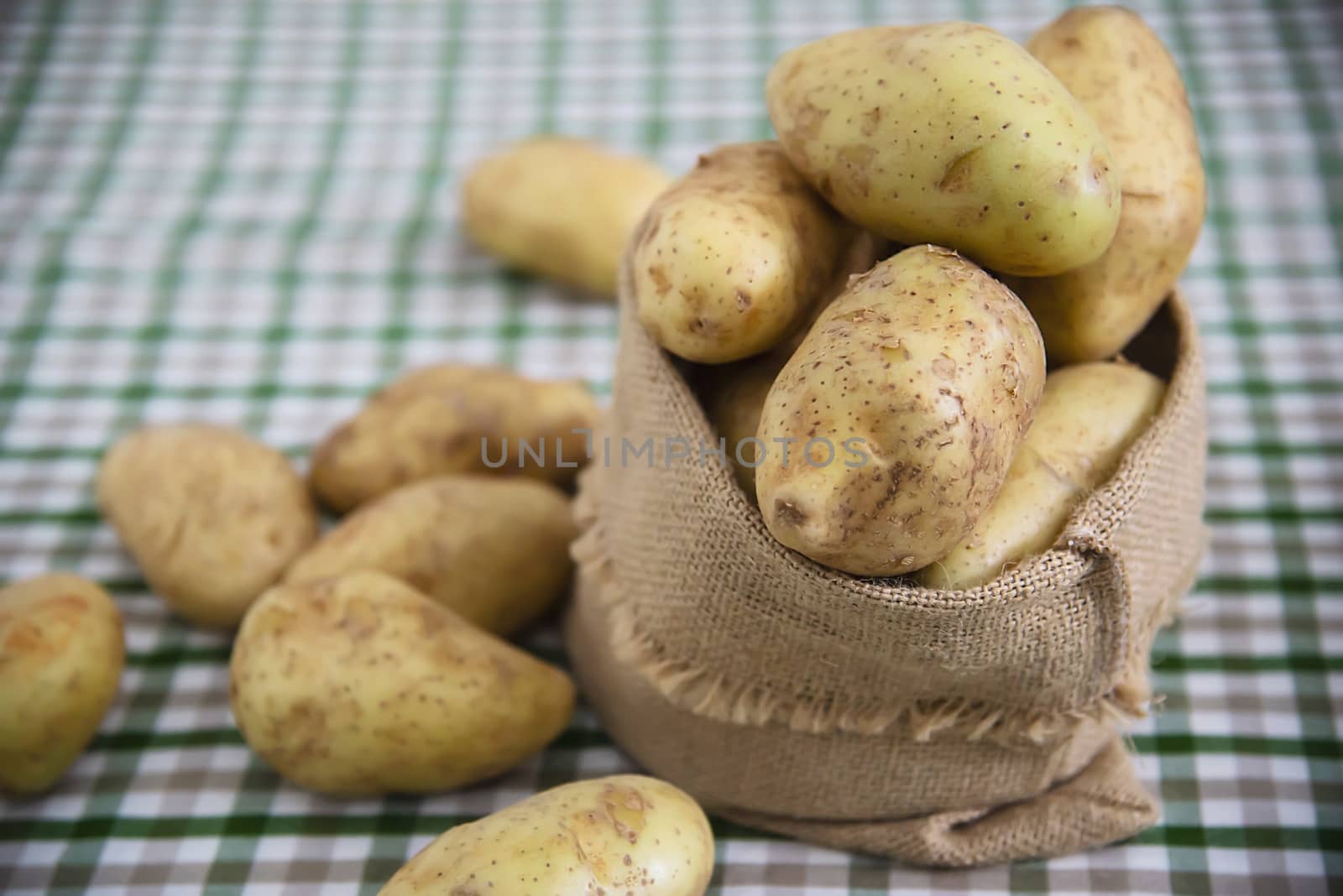 Fresh potato in kitchen ready to be cooked - fresh vegetable preparing for making food concept