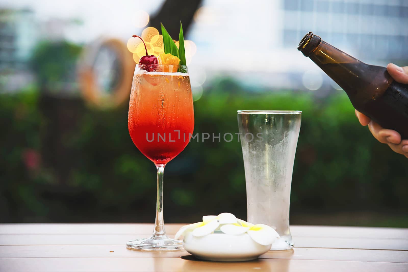 People celebration in restaurant with beer and mai tai or mai thai - happy lifestyle people with happy drink in garden concept by pairhandmade