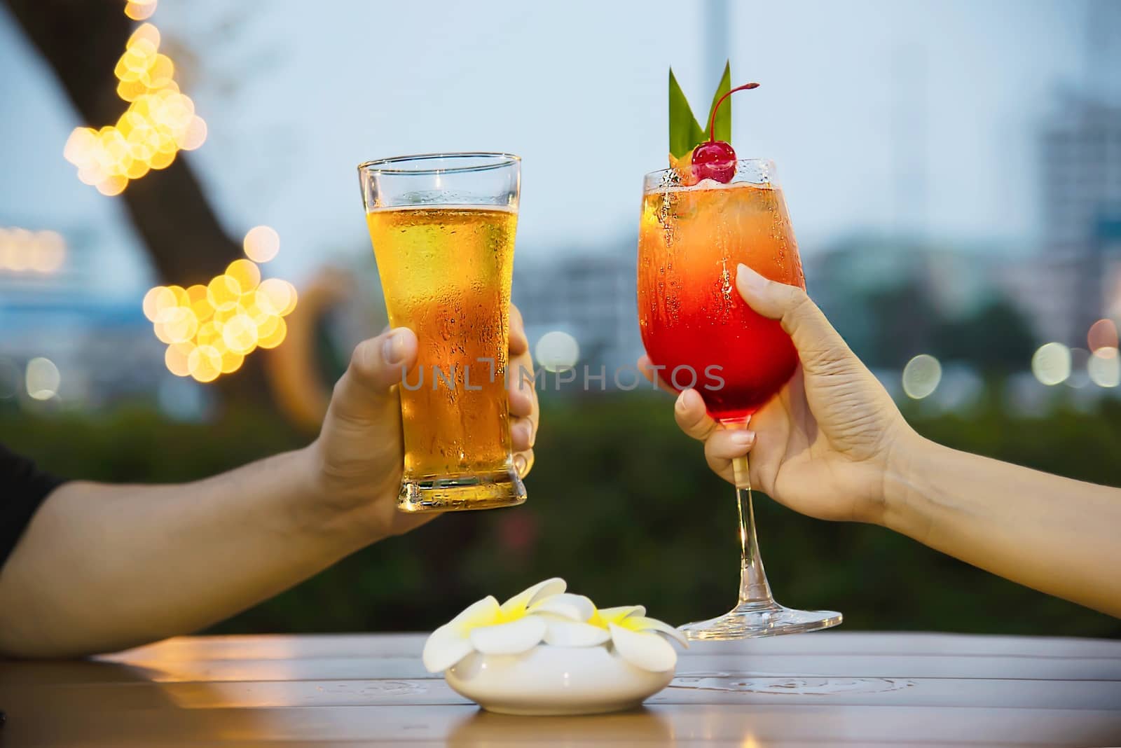 Couple celebration in restaurant with soft drink beer and mai tai or mai thai - happy lifestyle people with soft drink concept by pairhandmade