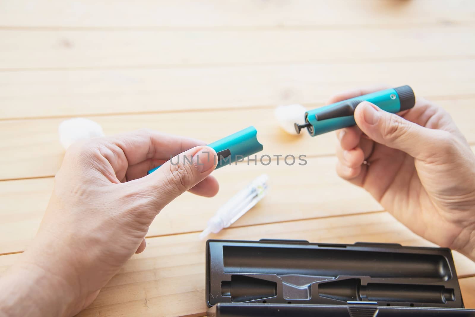 Man preparing insulin diabetic syringe for injection - people diabetic health care concept by pairhandmade