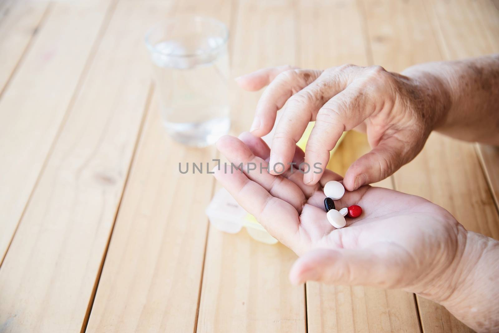 Old lady prepare to eat daily medicine pill - people healthcare with medicine pills concept