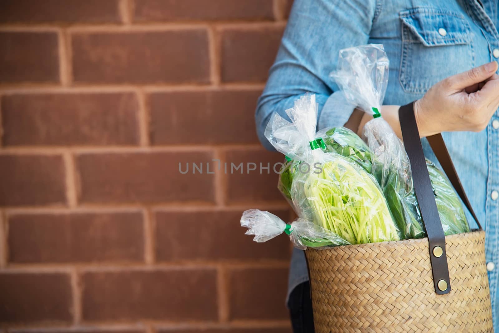 Lady is shopping fresh vegetable in supermarket store - woman in fresh market lifestyle concept
