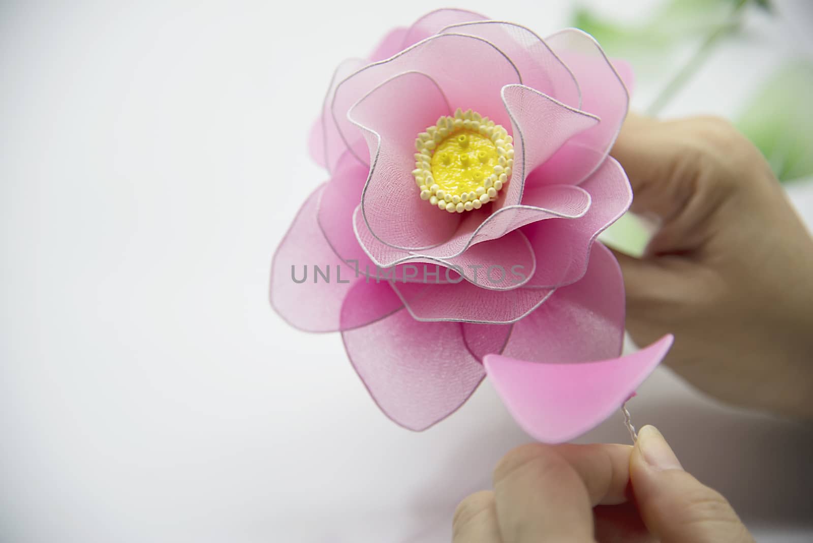 Woman making beautiful nylon flower - people with DIY handmade flower concept by pairhandmade