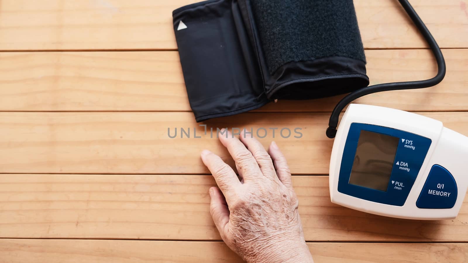 Old lady is being checked blood pressure using blood pressure monitor kid set - people with health care medical instrument set concept by pairhandmade