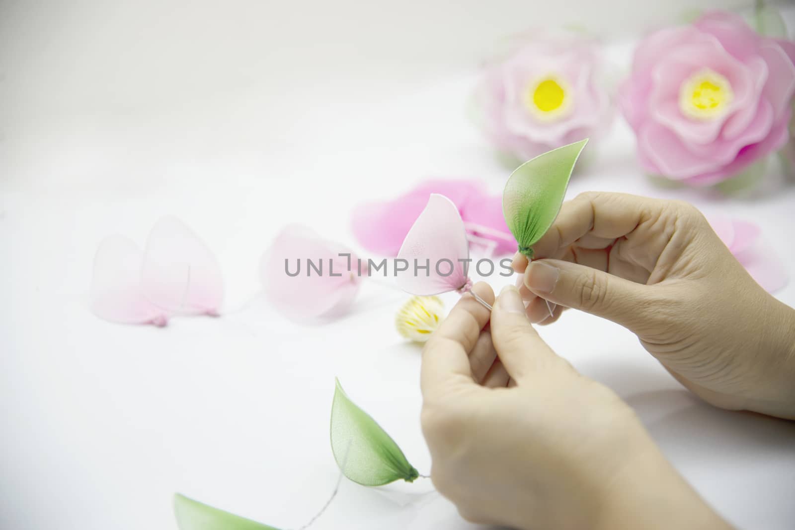 Woman making beautiful nylon flower - people with DIY handmade flower concept by pairhandmade