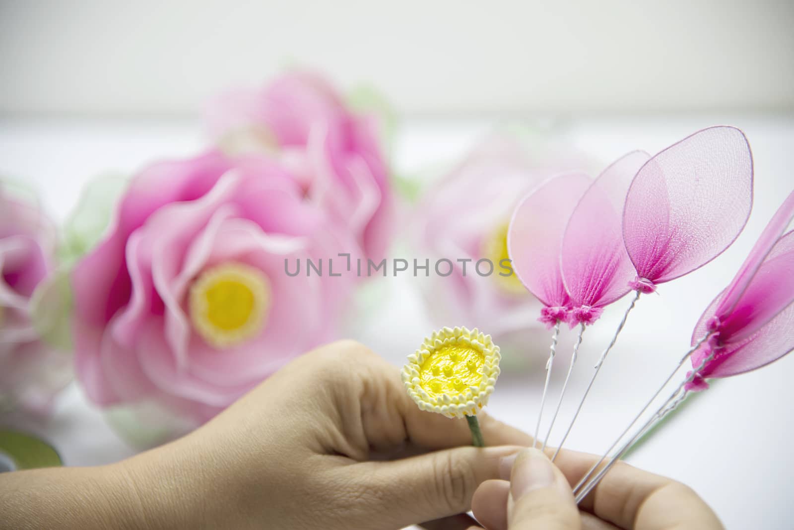 Woman making beautiful nylon flower - people with DIY handmade flower concept by pairhandmade