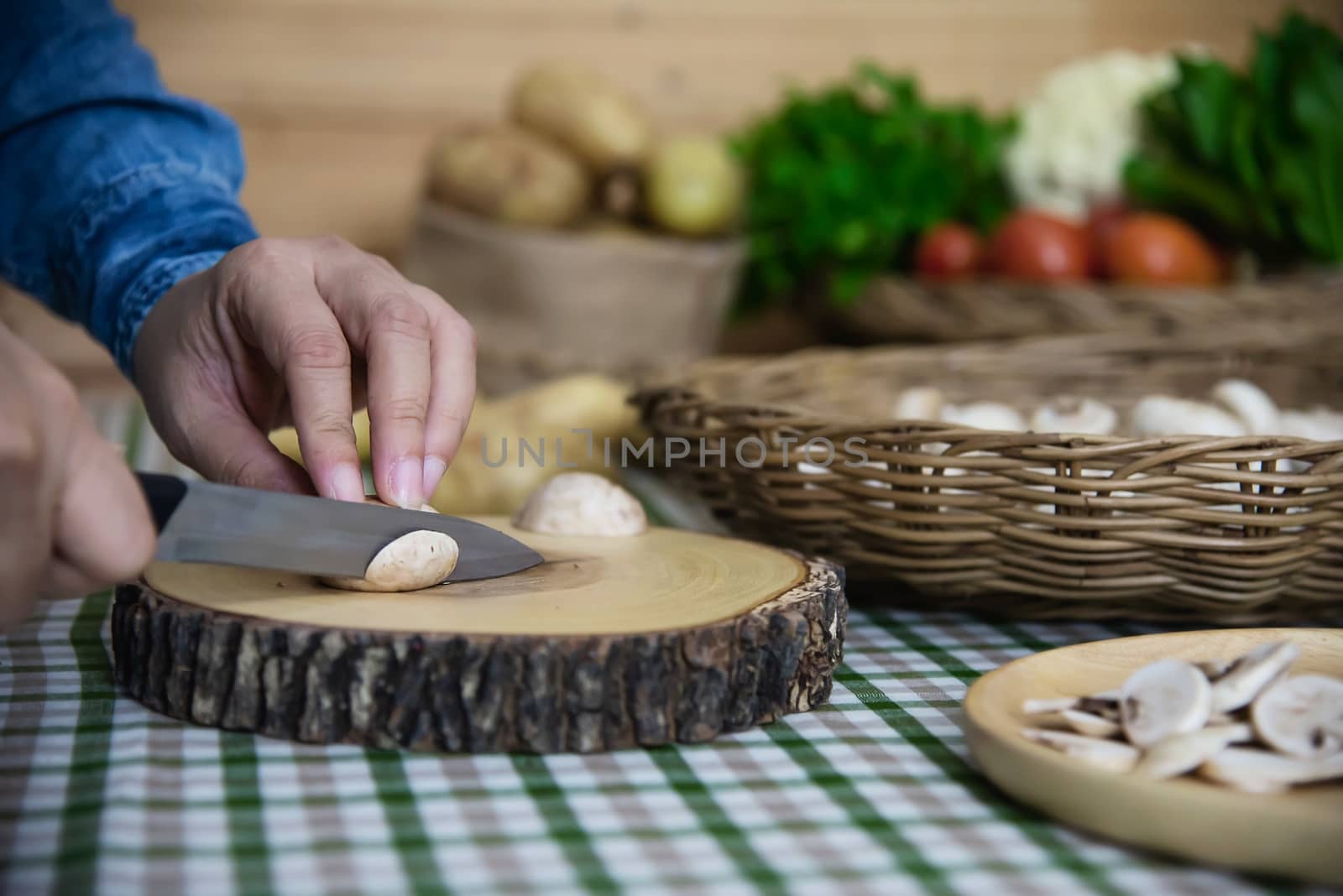 Lady cooks fresh champignon mushroom vegetable in the kitchen - people with vegetable cooking concept
