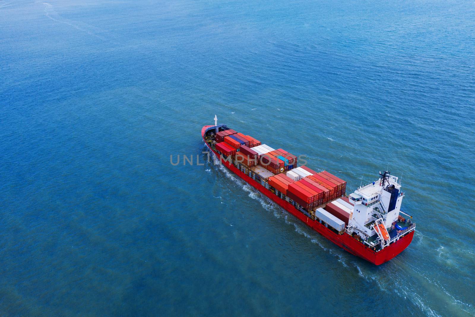 Aerial view of container cargo ship in sea.