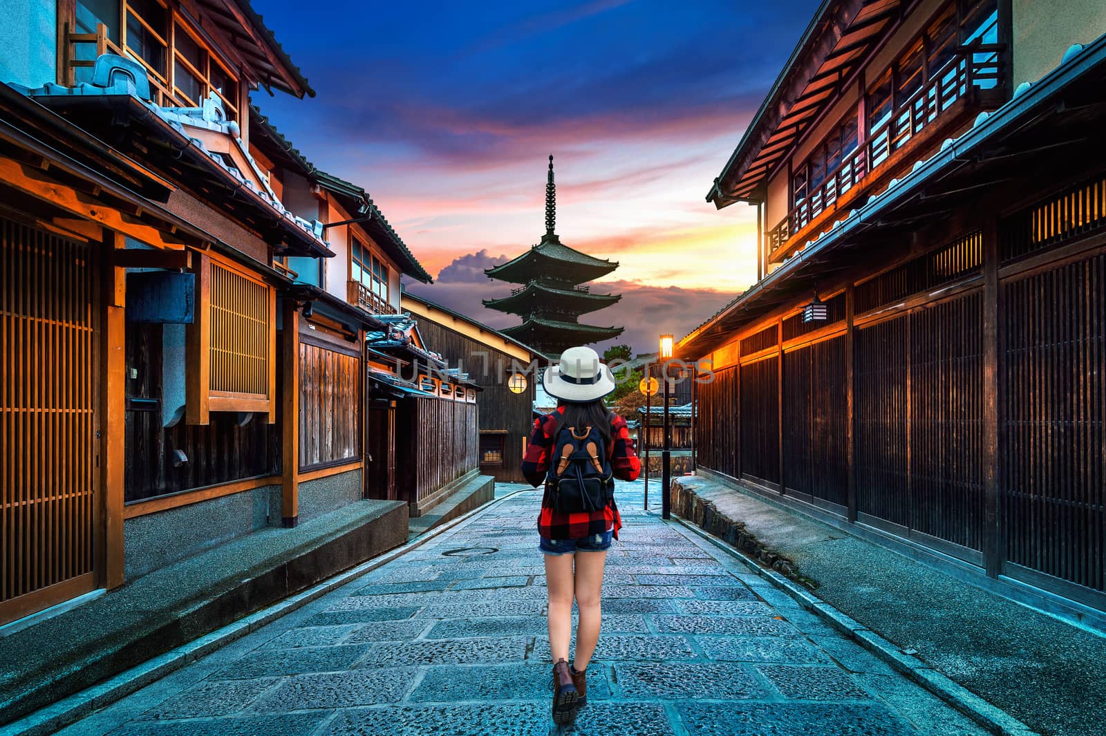 Woman traveler with backpack walking at Yasaka Pagoda and Sannen Zaka Street in Kyoto, Japan. by gutarphotoghaphy