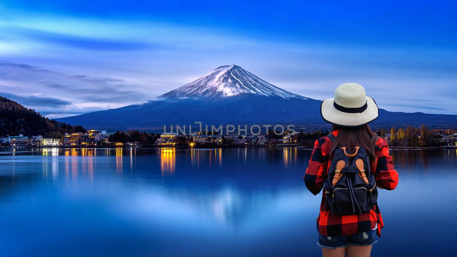 Woman traveler with backpack looking to Fuji mountains in Japan. by gutarphotoghaphy