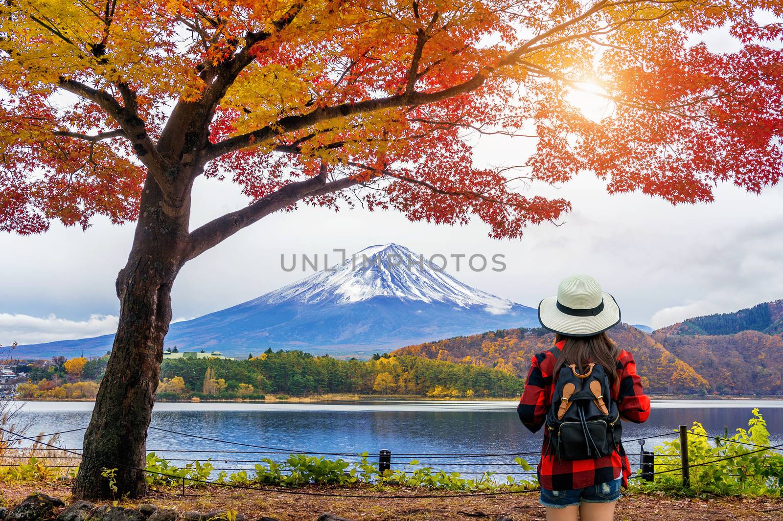 Woman traveler with backpack looking to Fuji mountains in Autumn, Japan. by gutarphotoghaphy