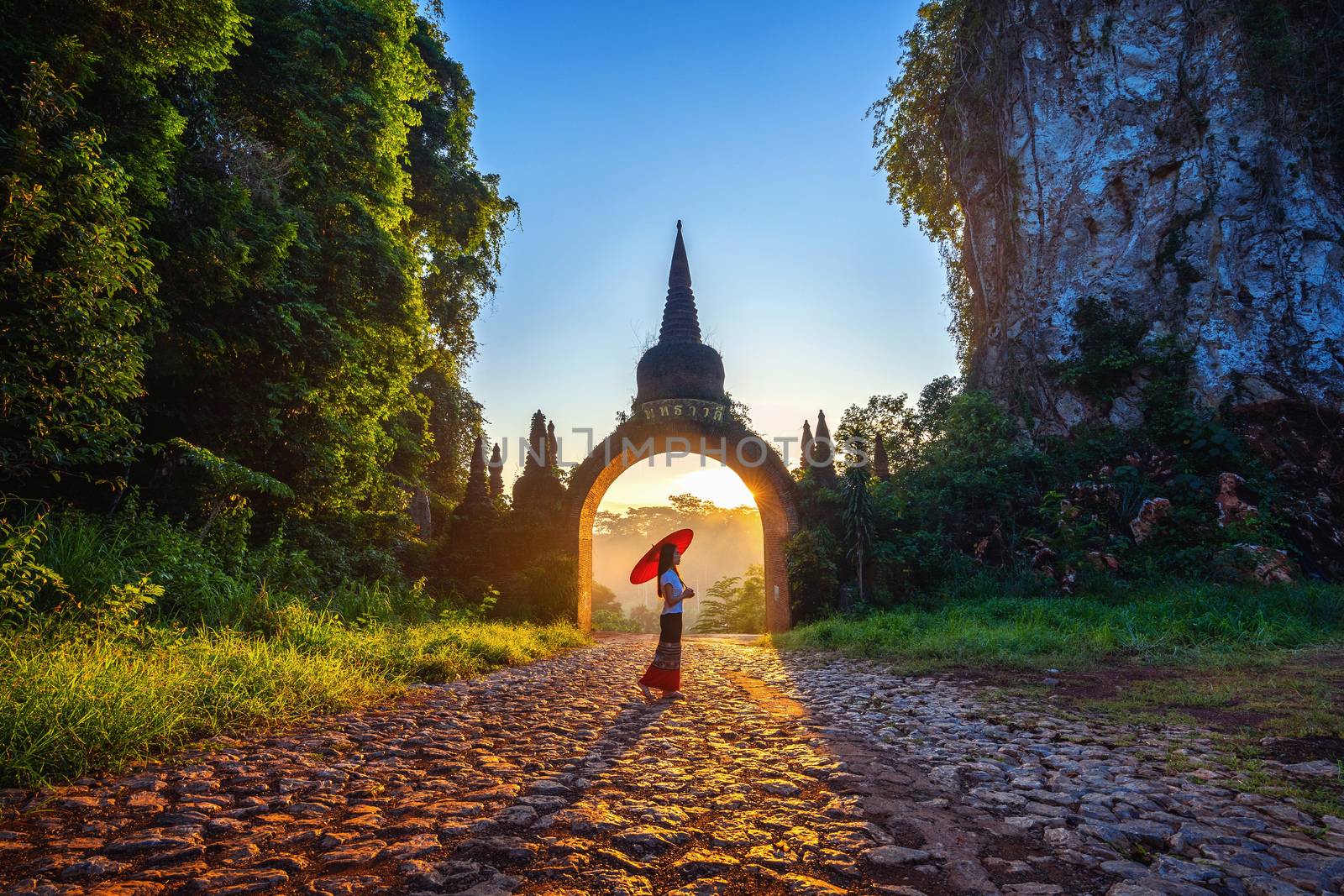 Woman standing at Khao Na Nai Luang Dharma Park in Surat Thani, Thailand by gutarphotoghaphy
