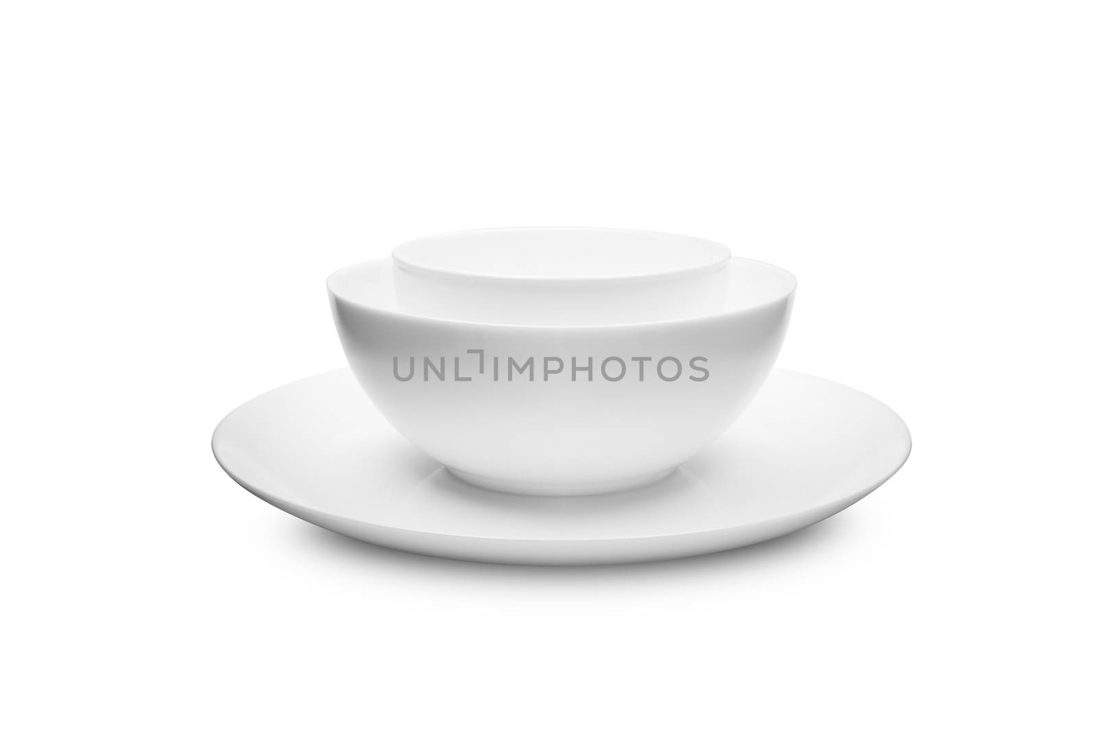 Set of white dishes on table on light background. With clippig path