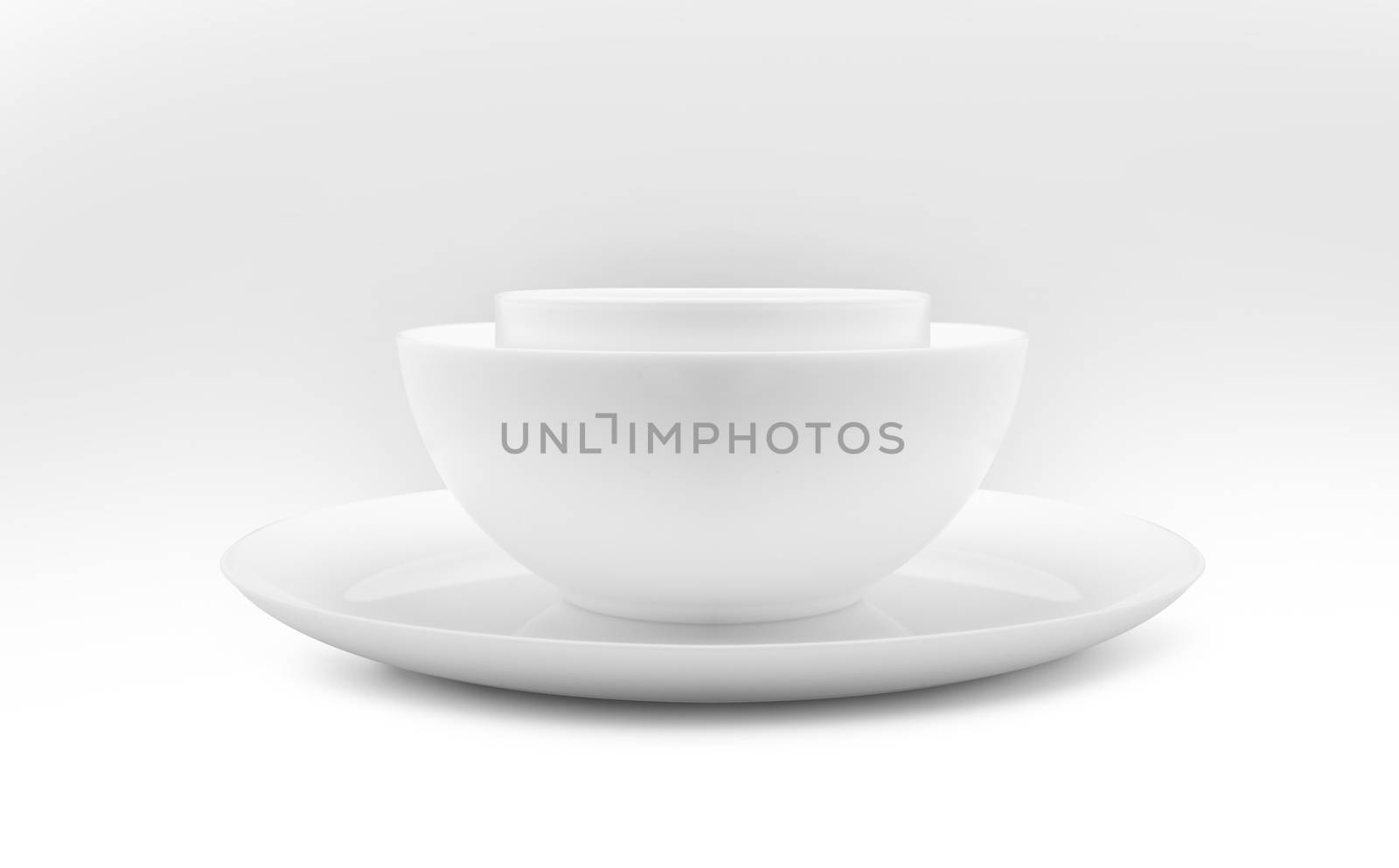 Set of white dishes on table on light background. With clippig path