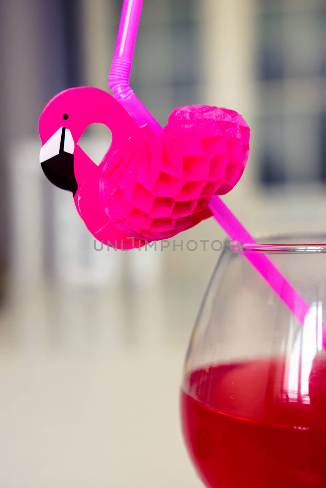 drink red with decorative drinking tube decorated with Flamingo figure by alexandr_sorokin