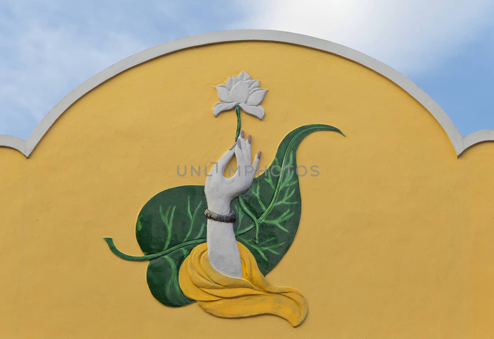 Wall relief: hand with lotus flower, Nha Trang, Vietnam