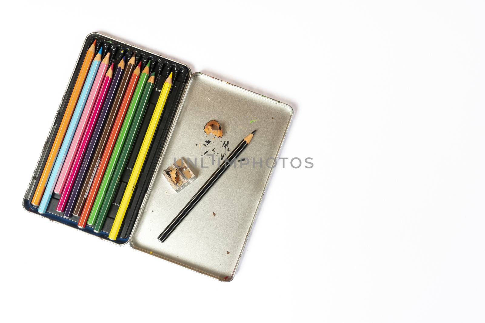 a metal box of colored pencils and a pencil sharpener