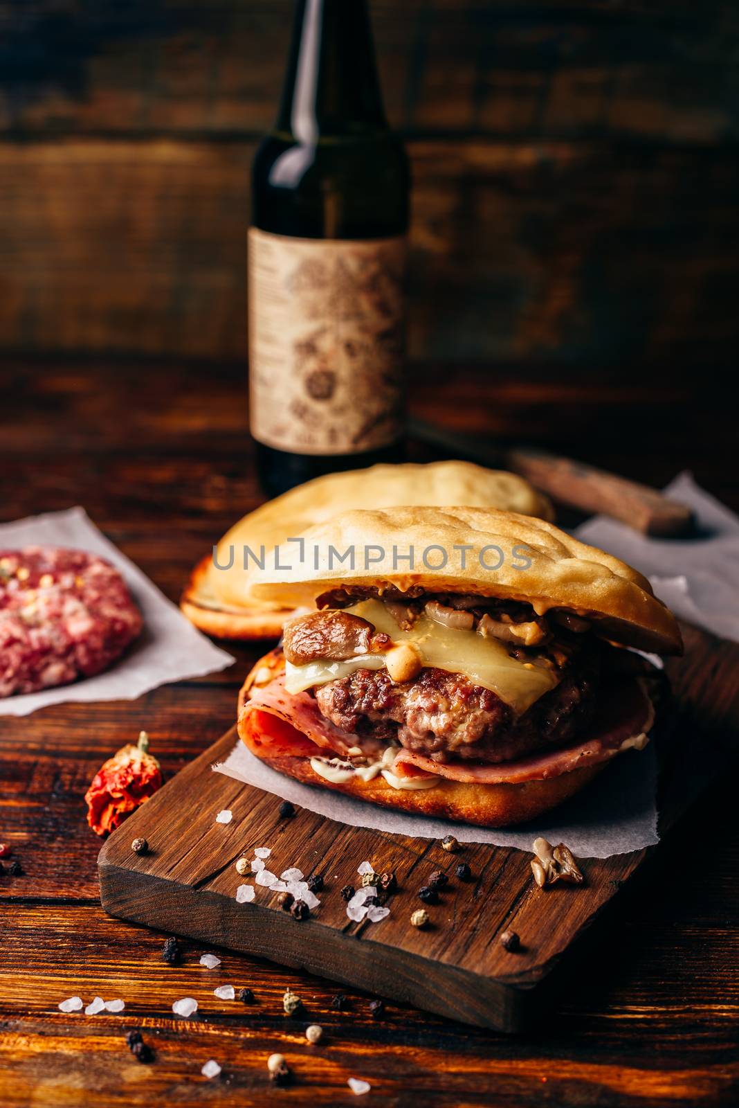 Cheeseburger on Cutting Board with Bottle of Craft Beer.