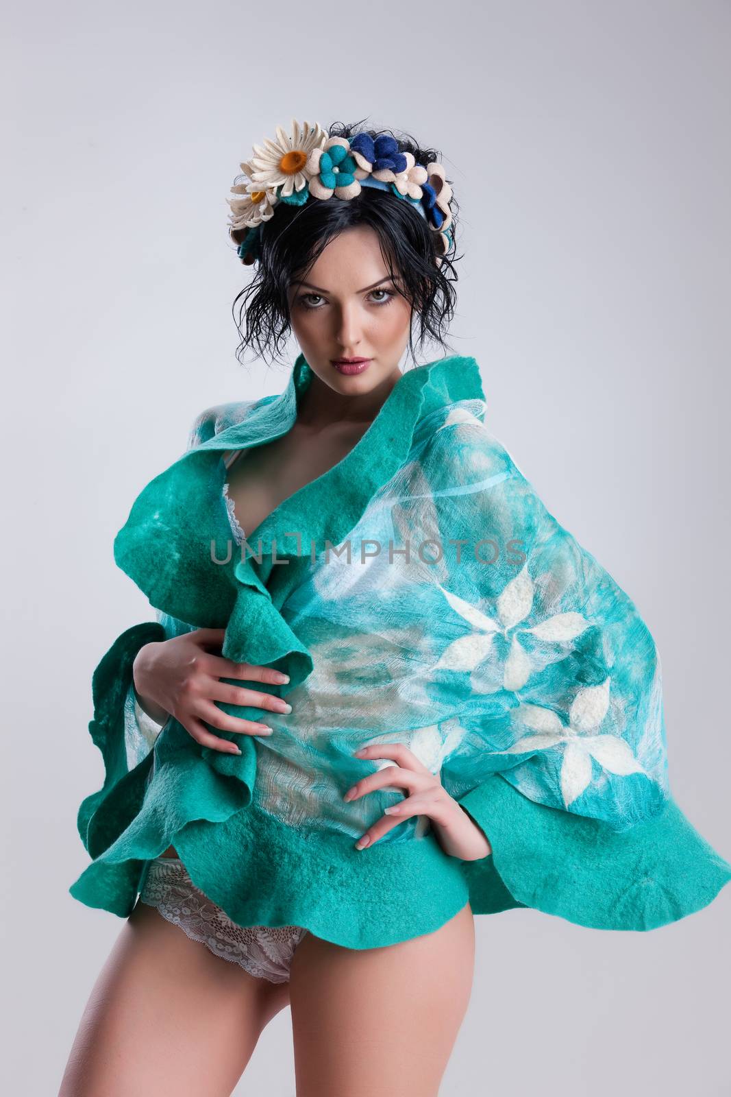 Young attractive woman dressed in handmade clothing on isolated background