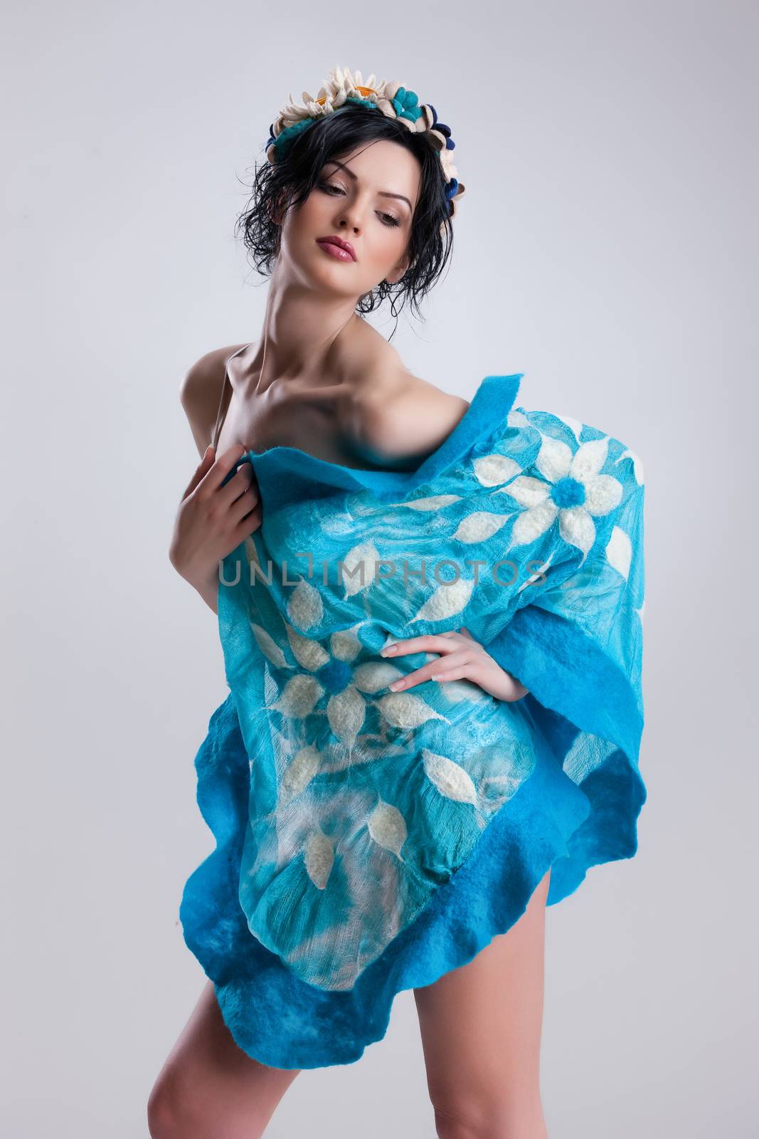 Young attractive woman dressed in handmade clothing on isolated background