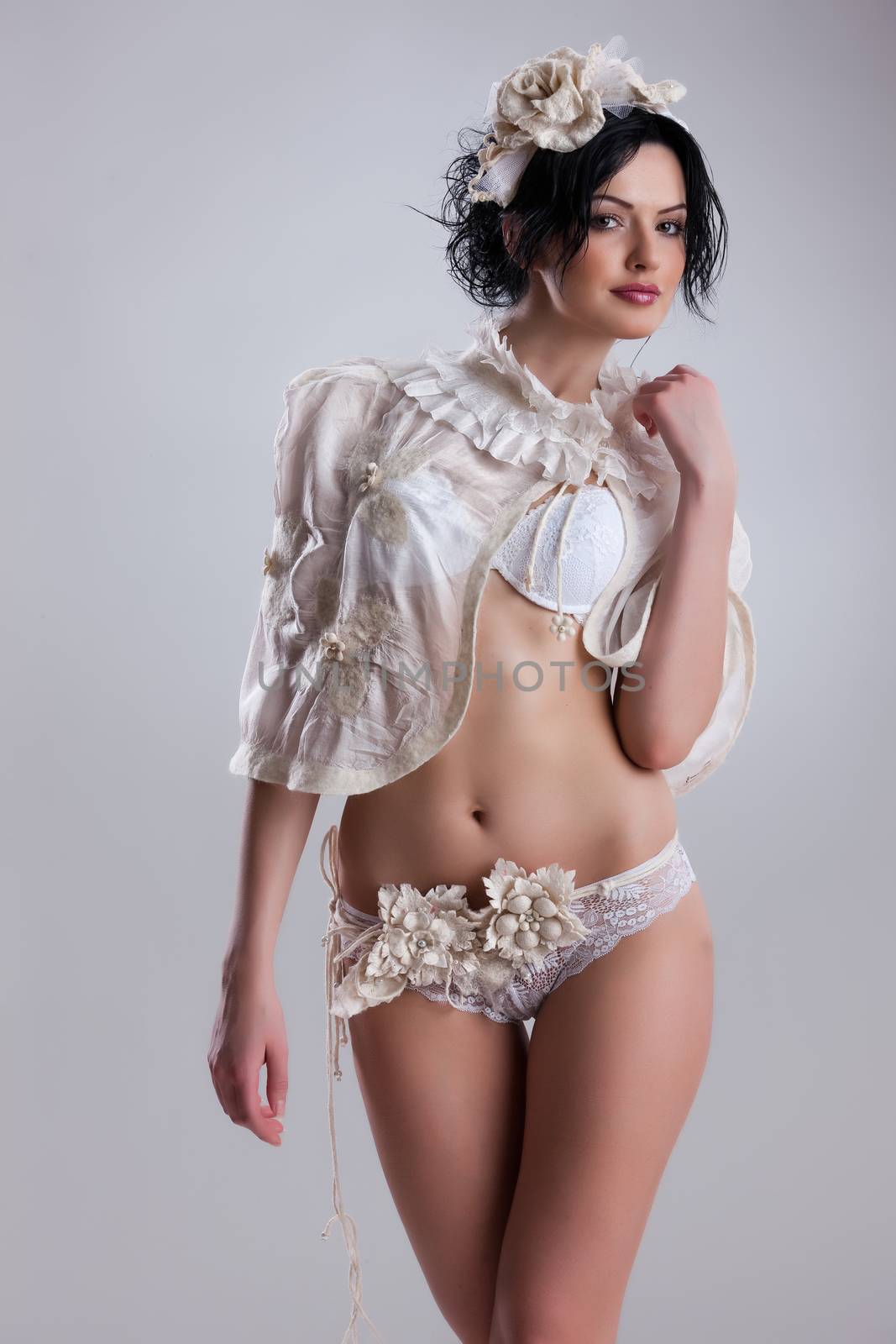 Young attractive woman dressed in handmade clothing on isolated background