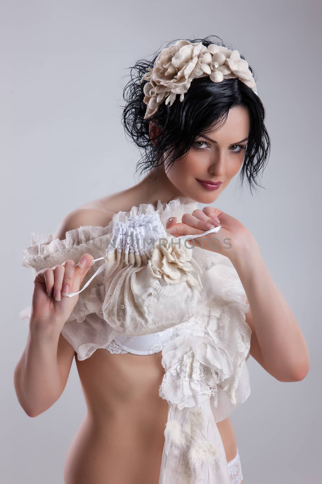Young attractive woman dressed in handmade clothing on isolated background