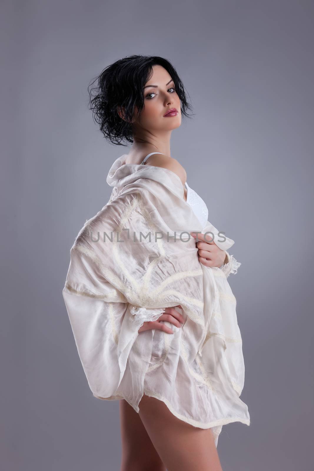 Young attractive woman dressed in handmade clothing on isolated background