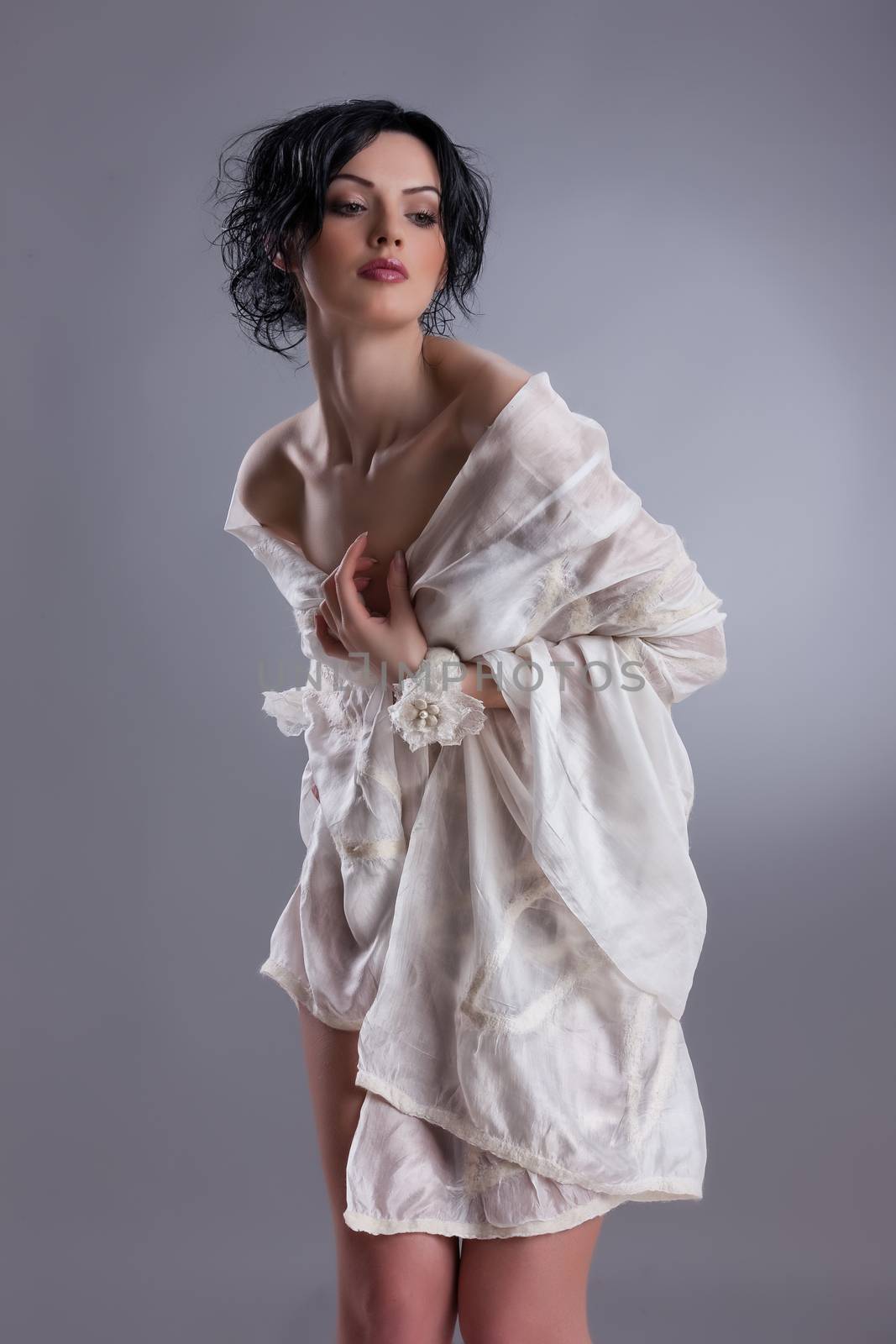 Young attractive woman dressed in handmade clothing on isolated background