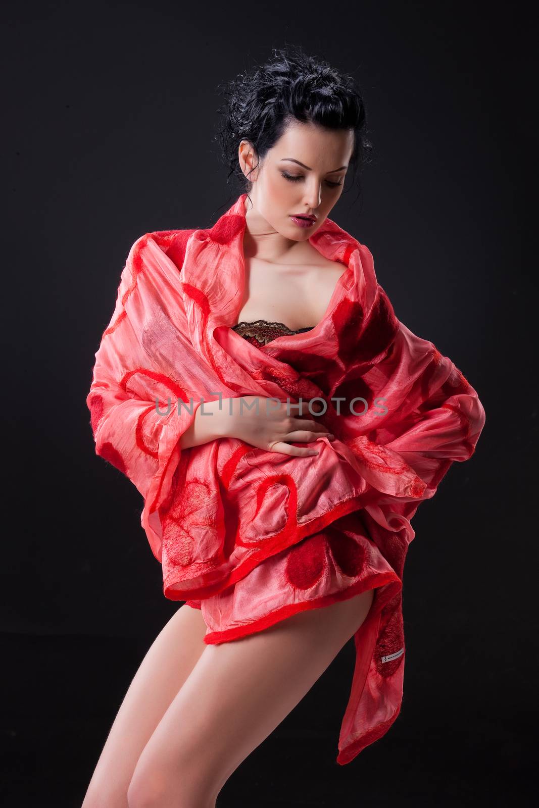 Young attractive woman dressed in handmade clothing on isolated background