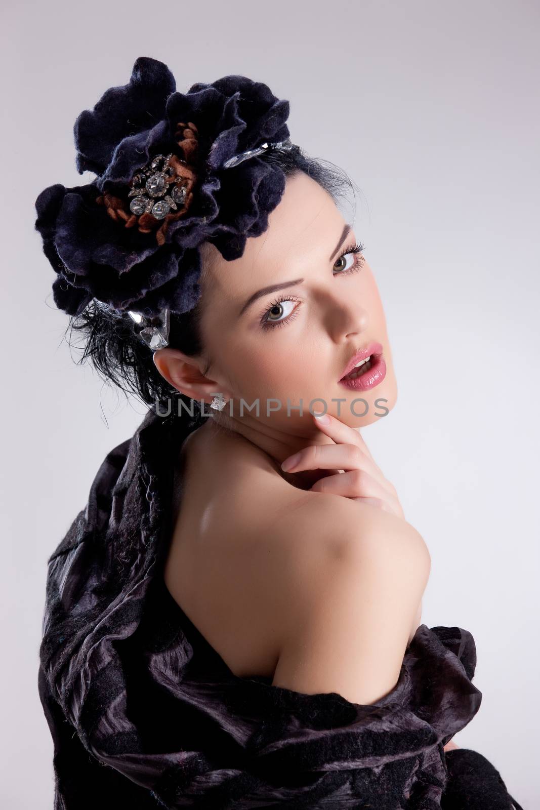 Young attractive woman dressed in handmade clothing on isolated background